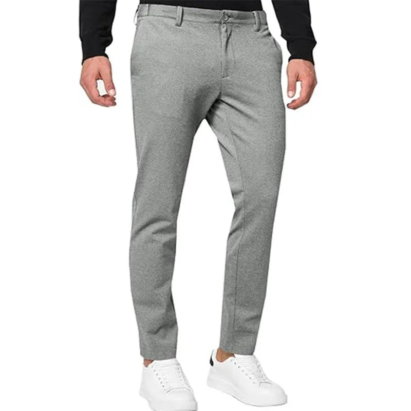 Men's slim-fit tapered chino trousers in a cotton blend stretch fabric on a hanger.