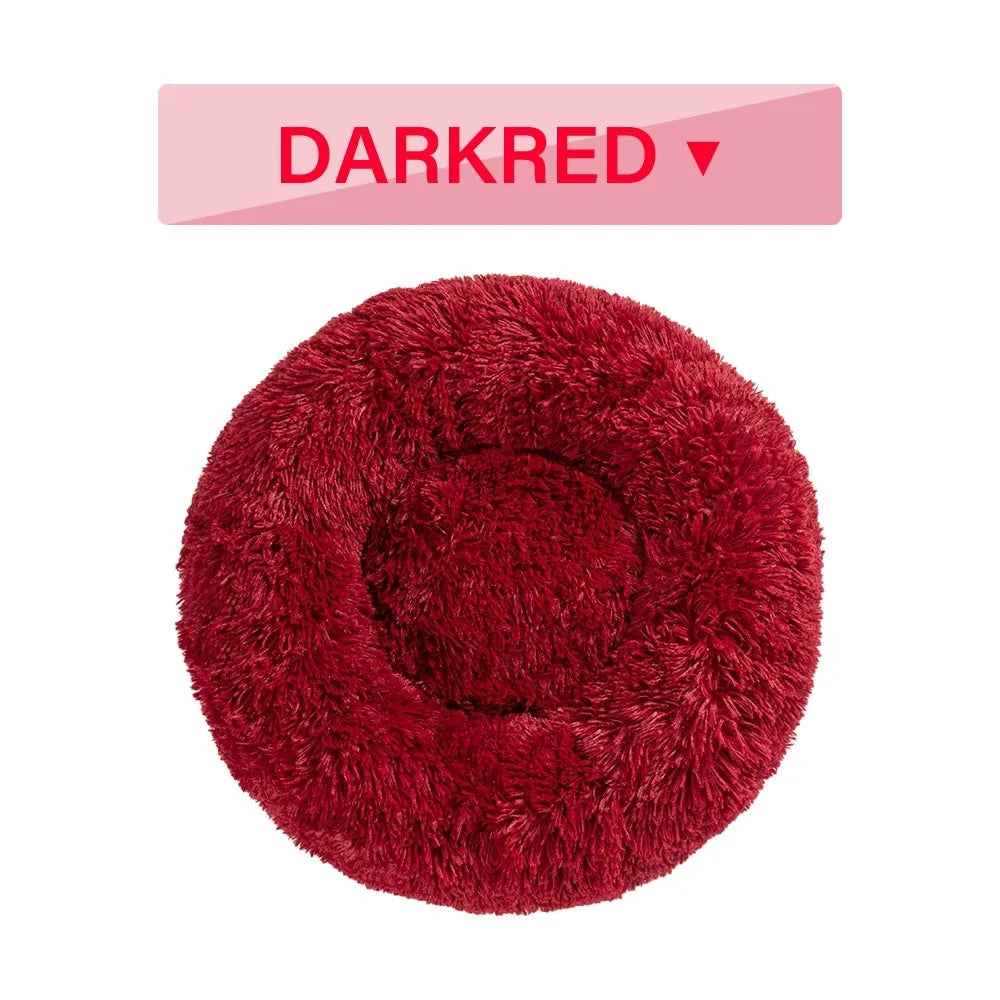 A round donut-shaped dog bed with a raised plush rim, shown in a light grey colour.