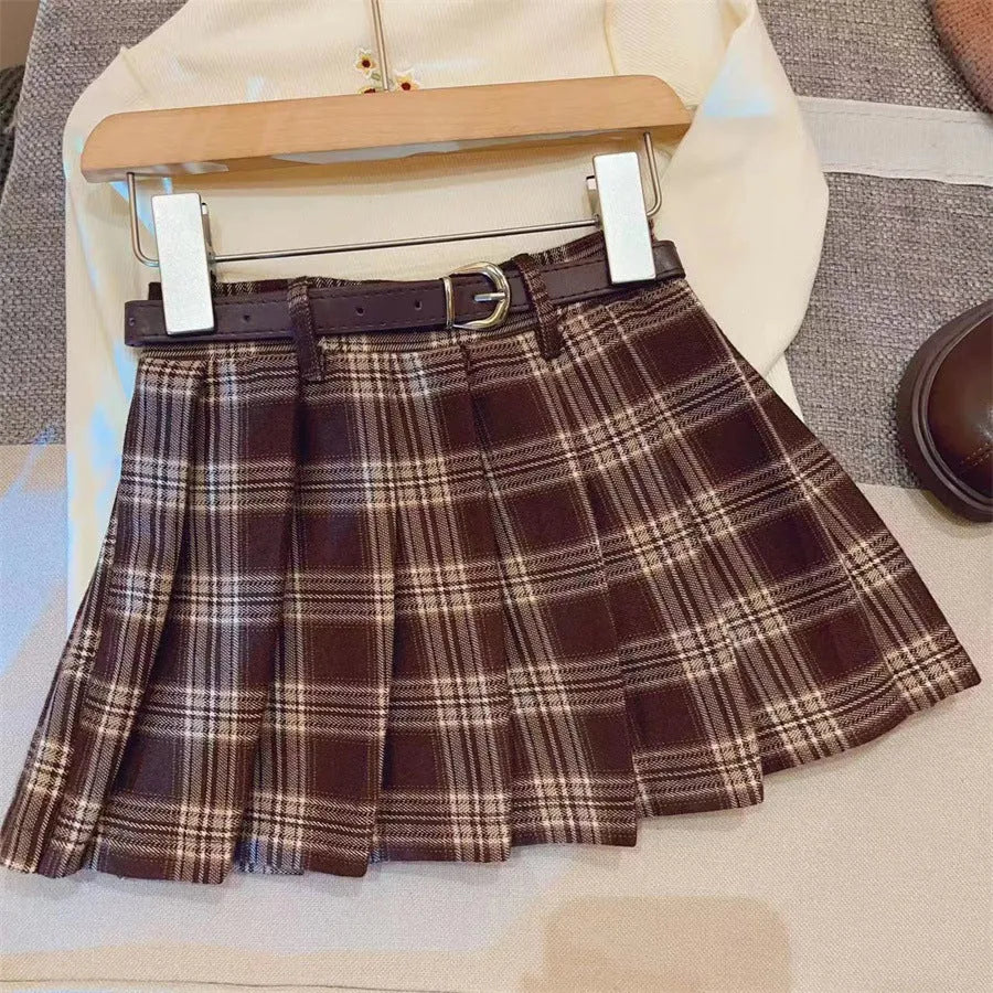 Girls plaid pleated A-line skirt in cotton-blend fabric on a hanger.