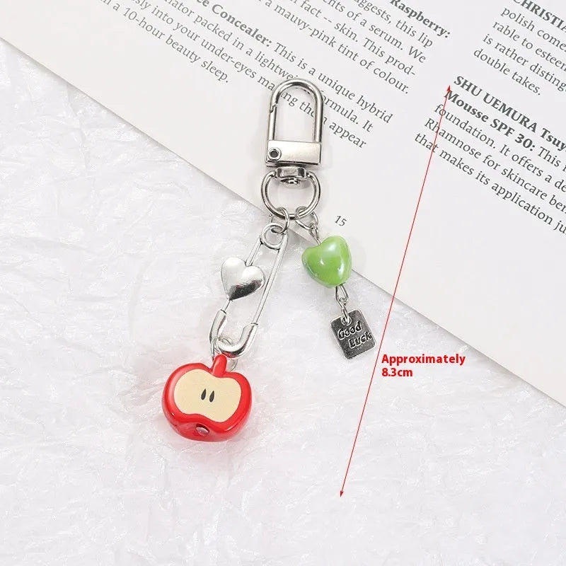 Cute fruit design mobile phone charm keychain in plastic resin with apple or strawberry motif.