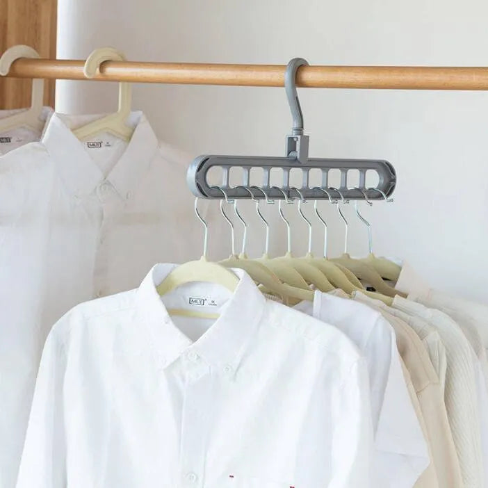 Plastic clothes hanger with a rotating hook in assorted colours on a white background.