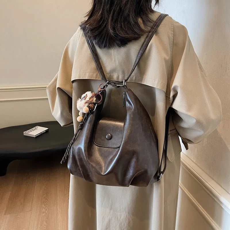 Women's black PU leather single shoulder bag with horizontal square shape and optional pendant attachment