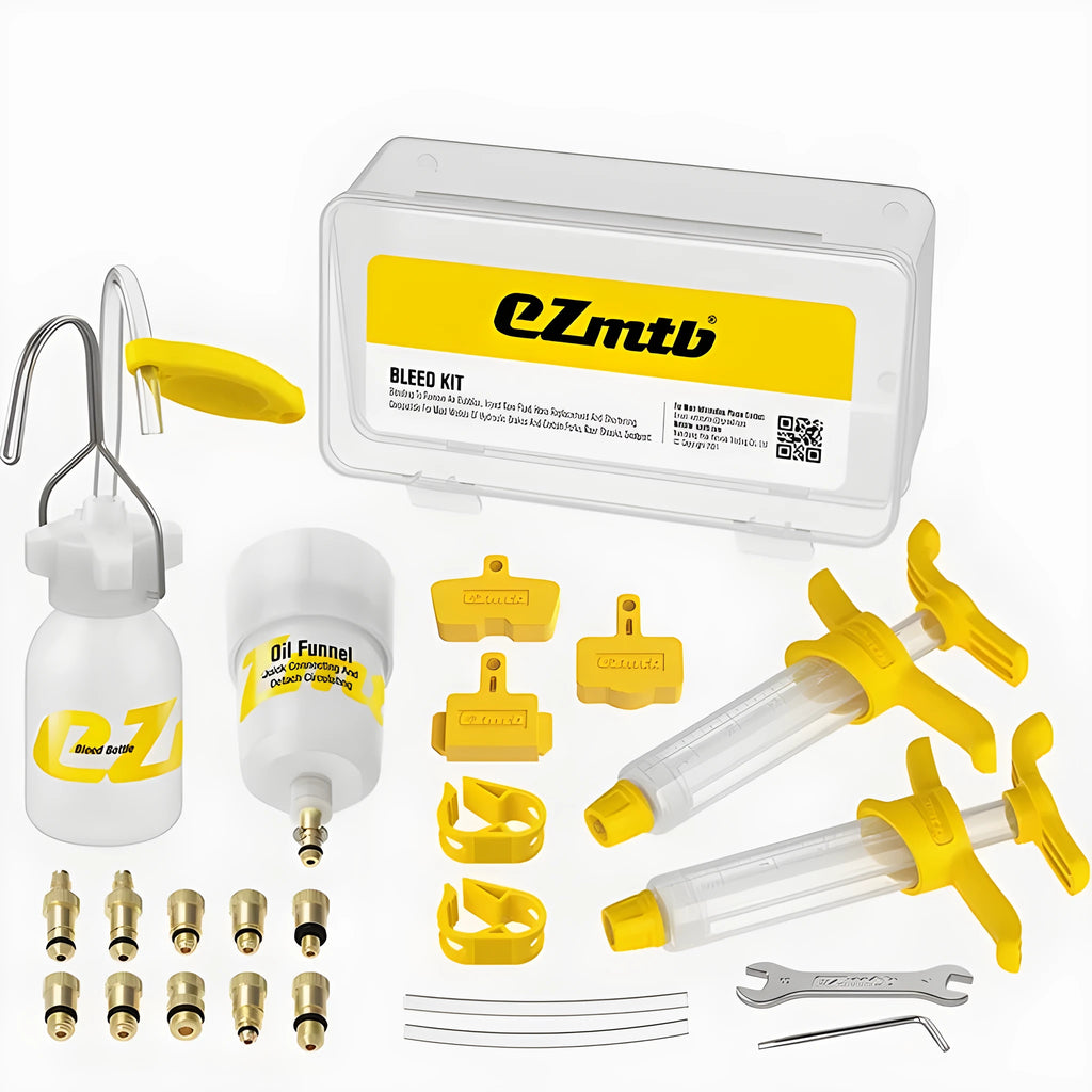 EZmtb bicycle hydraulic disc brake bleed kit with syringes, bottles, wrenches, and adapters on a workbench