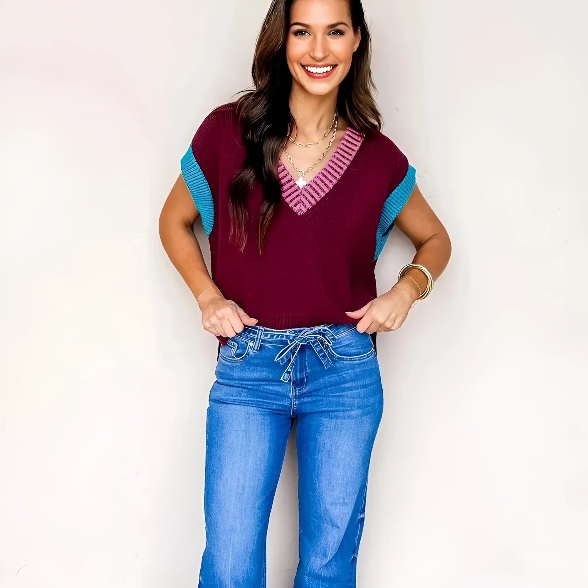 Burgundy v neck short sleeve sweater with contrast trim and loose fit on a woman
