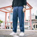 Men's loose straight jeans in dark blue, light blue, and grey colours showing mid waist and straight-leg cut