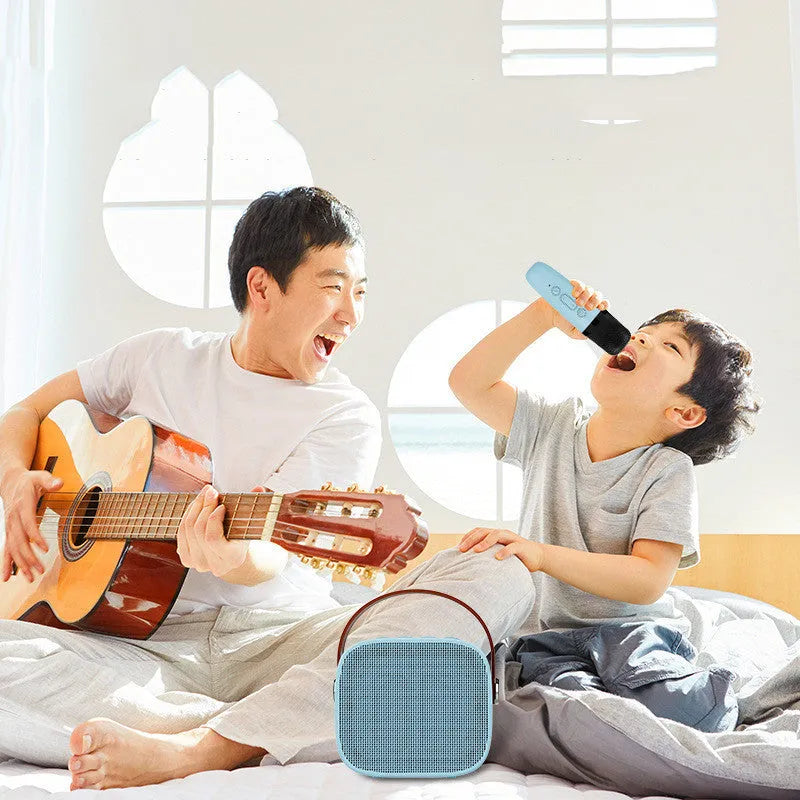 Compact white wireless Bluetooth speaker with USB port shown on a table.
