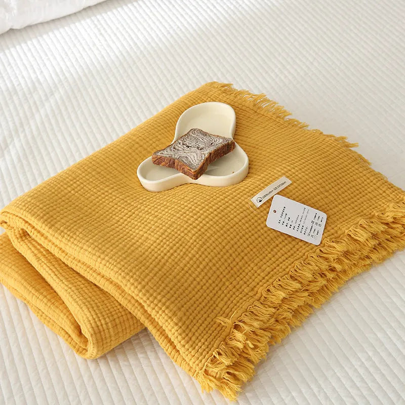 Four-layer cotton gauze blanket with tassel trim in avocado green colour