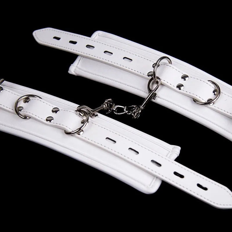 White PU sponge bondage restraint set showing handcuffs, foot cuffs and neck scarf for discipline play