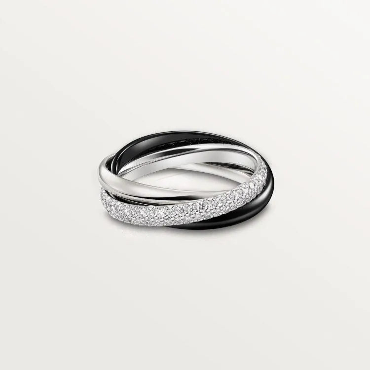 A pair of matching sterling silver U-shaped geometric couple rings with diamond accents on a black background.