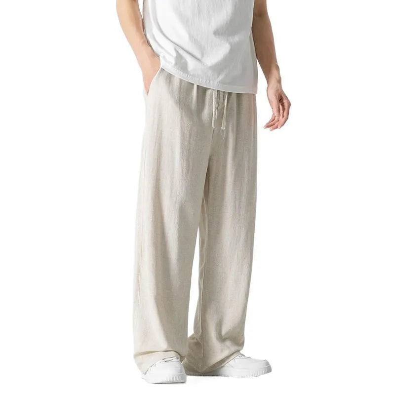 Men's beige bamboo fibre loose straight-leg casual trousers with a drawstring waist, shown on a hanger.