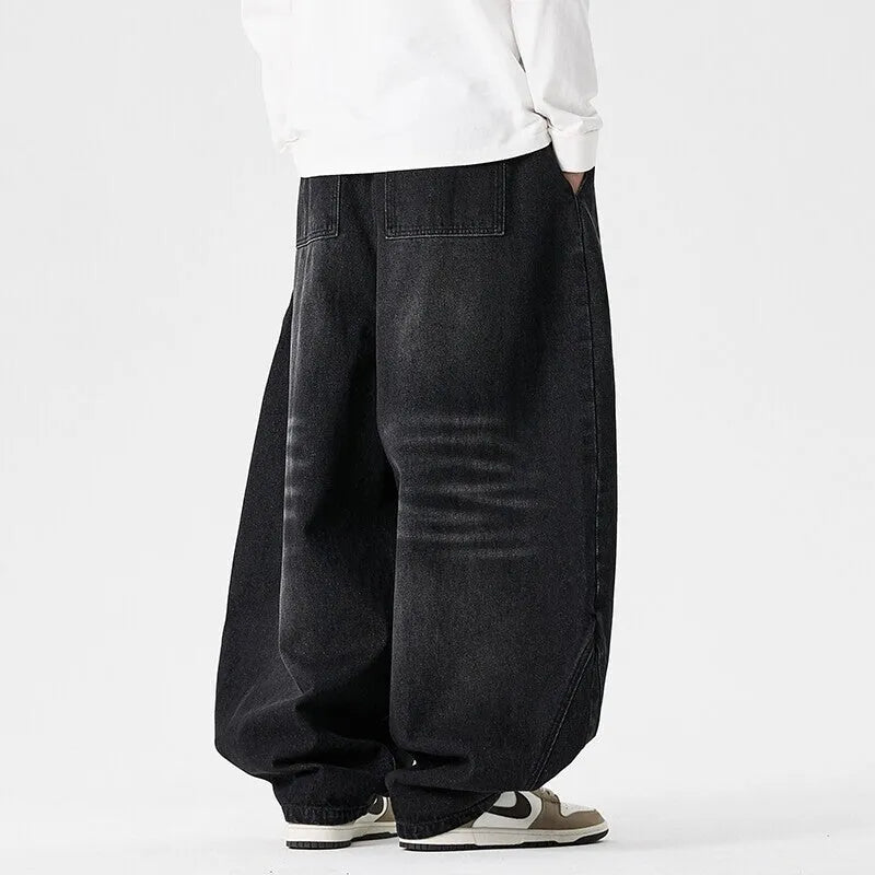 Men's plus size wide leg jeans in dark blue denim with a baggy fit and straight leg opening.