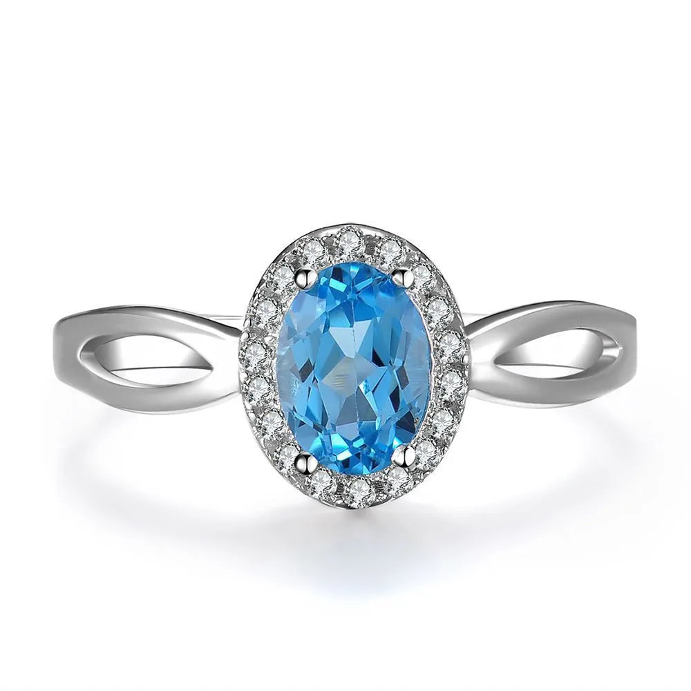 925 sterling silver jewellery set with blue topaz gems in geometric design including earrings, ring, necklace and pendant