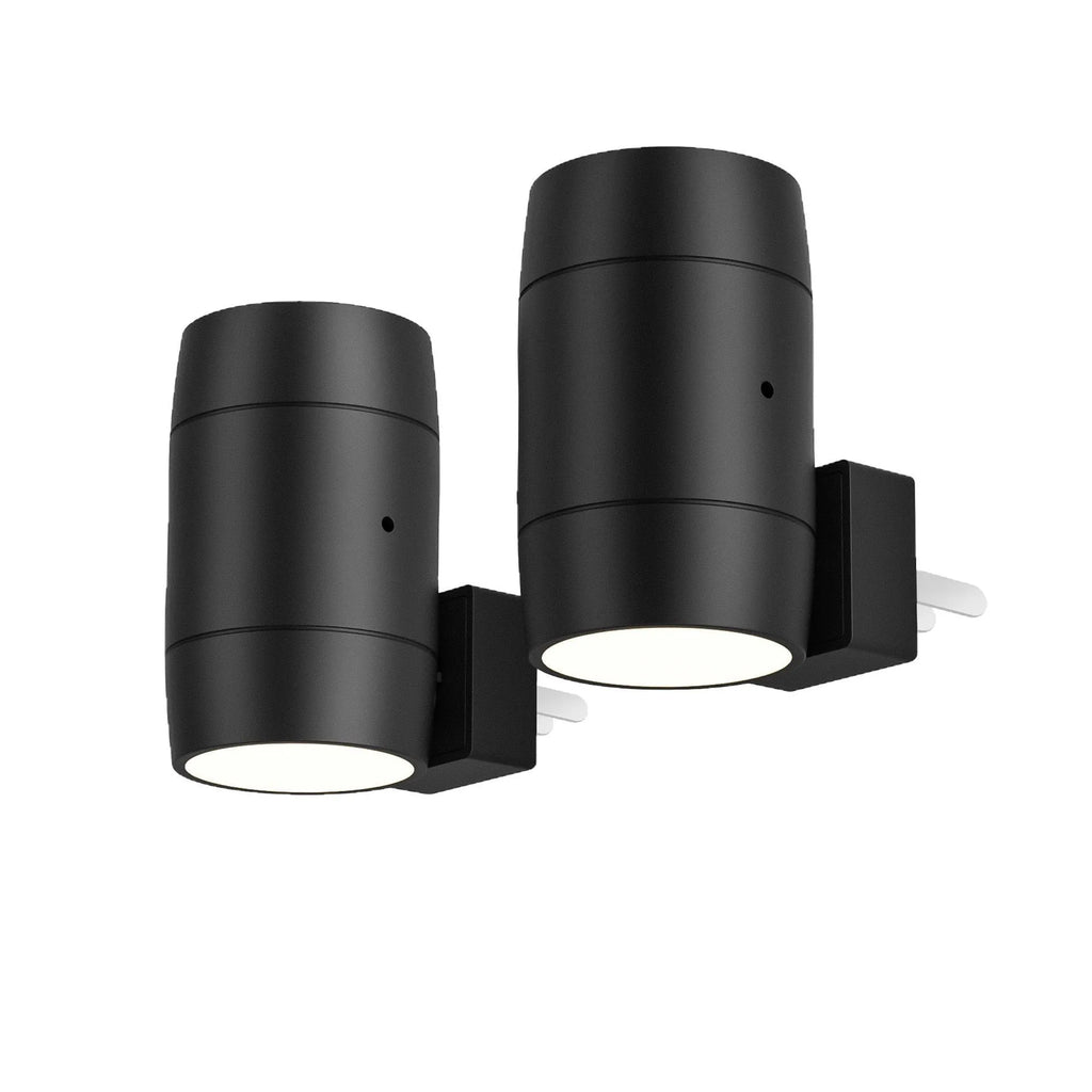 Small white plug-in night lamp with a rotatable light head on a bedside table.