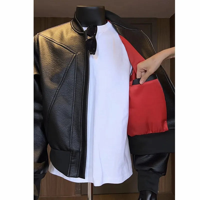 Men's black PU leather jacket with litchi grain texture, showing extended length and tight fit.