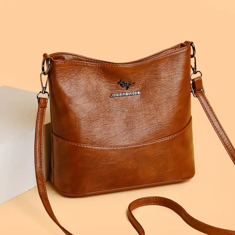 Women's soft leather large capacity bucket shoulder bag in minimalist luxury style with sewing line details.