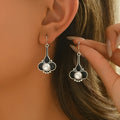 Pair of silver retro-style creative alloy earrings for women on a white background.