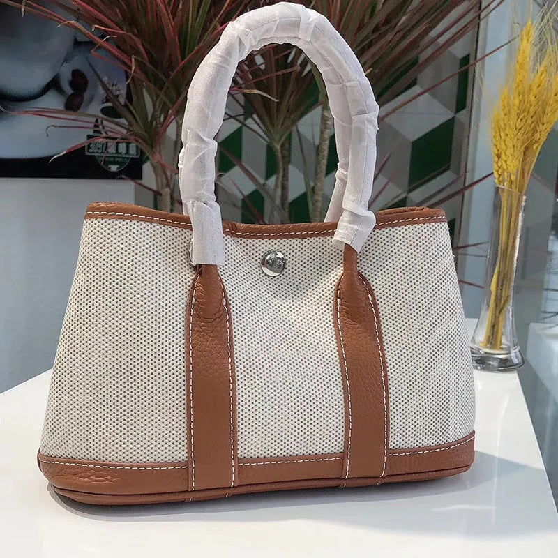 Women's canvas crossbody tote bag with leather detailing in bucket shape design