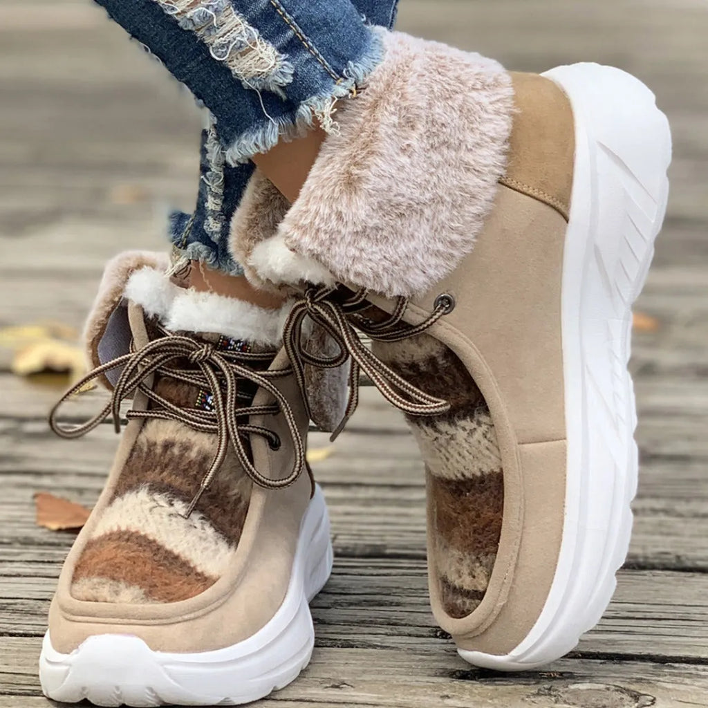 Beige women's lace-up suede snow boots with a thick sole and plush lining on a white background.