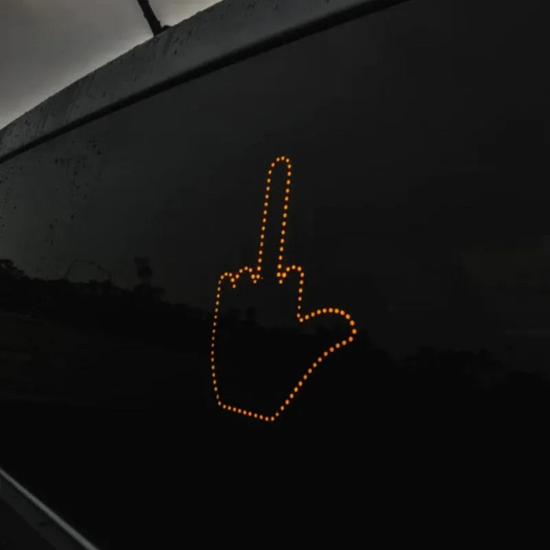 Black plastic LED gesture light for cars showing middle finger symbol with remote control