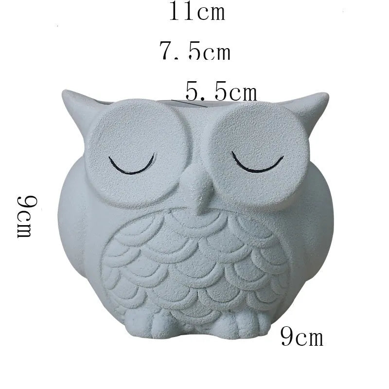 Handmade frosted ceramic owl planter for small succulents, shown in light pink.