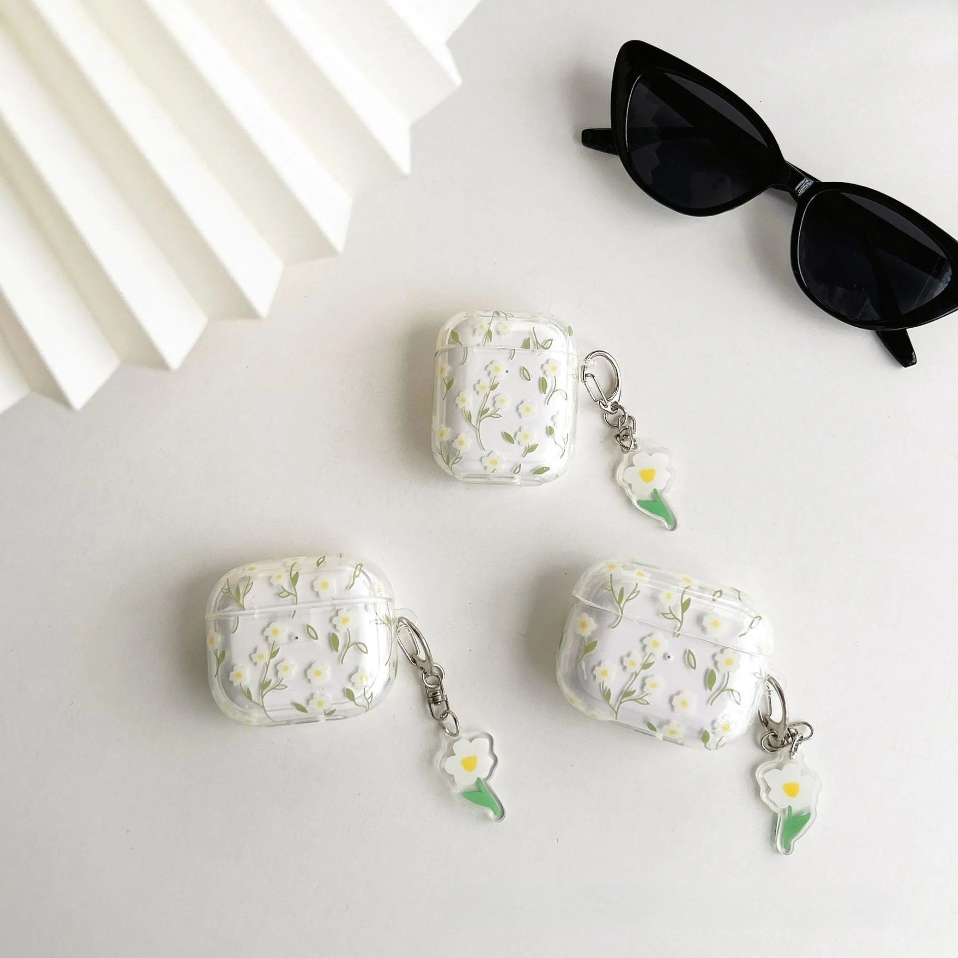 White floral design on a clear TPU protective cover for Apple AirPods case