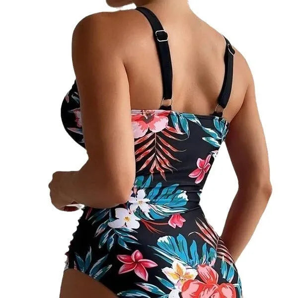 Women's black floral backless one-piece swimsuit on a mannequin