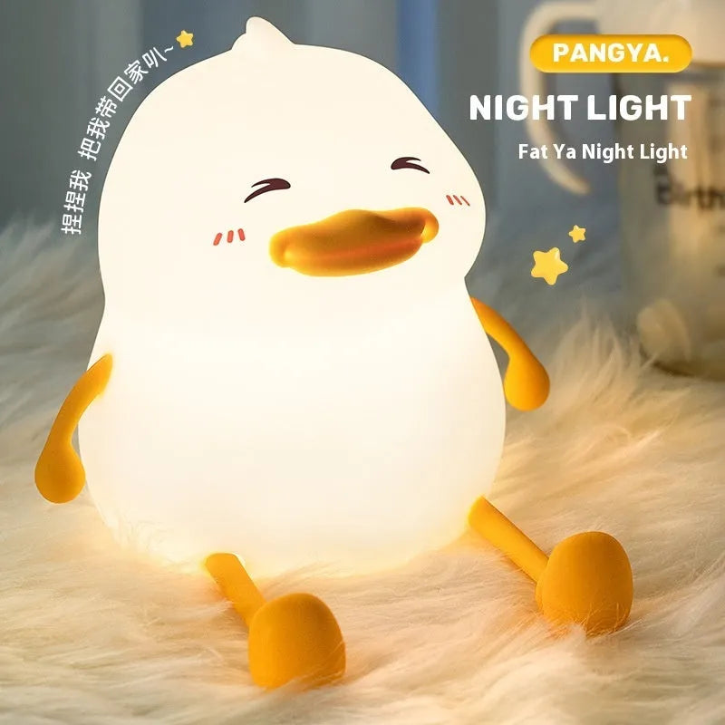 Chubby silicone rechargeable night light with phone holder on a desk