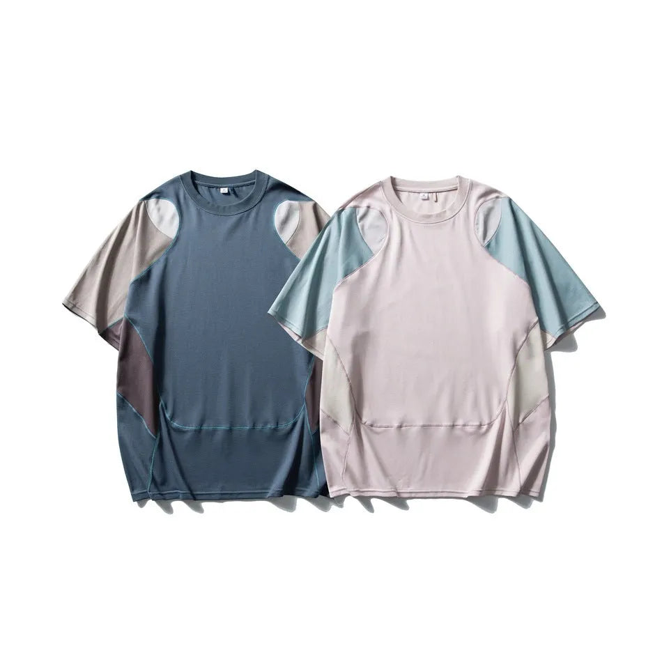 Man wearing a loose-fit patchwork contrast colour short sleeve cotton blend sports t-shirt.