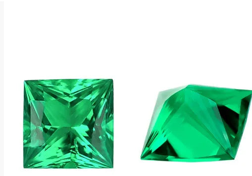 A loose cultivated emerald gemstone in Columbia green treasure colour on a white background.