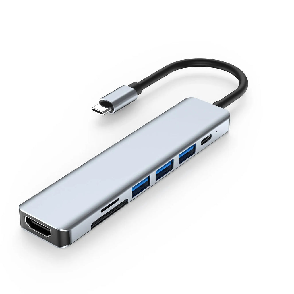 USB-C 7-in-1 hub expander with short cable, showing HDMI, VGA, and USB ports.