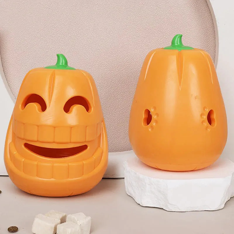 Orange Halloween pumpkin shaped interactive dog chew toy with treat-dispensing funnel.