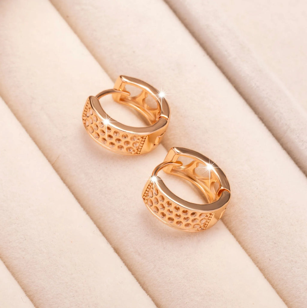 Rose gold electroplated earrings with hollow three-heart design in circular shape