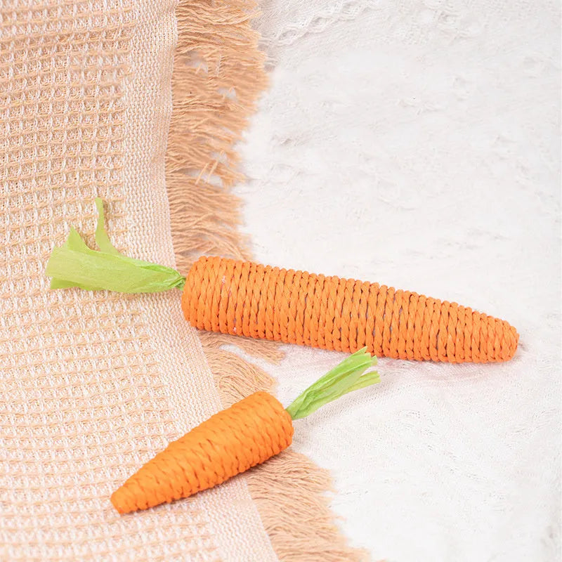 Assortment of cat toys including carrot-shaped bites, crinkly paper toys, ringing stones, sticks, and tooth grinding sticks.