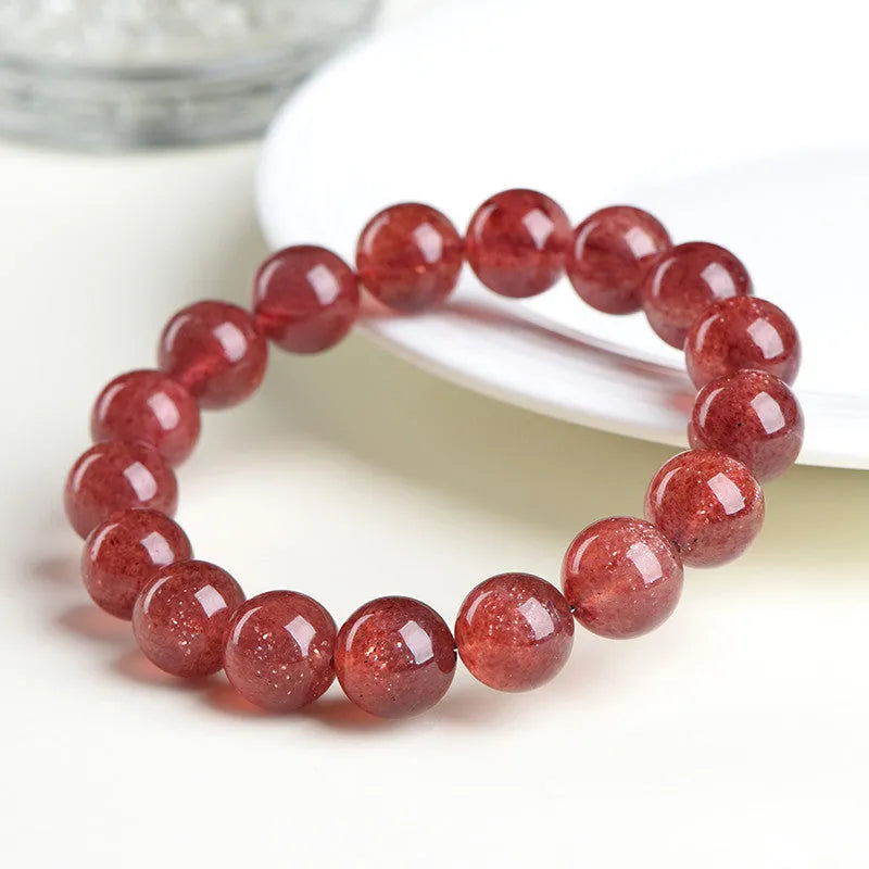 Natural strawberry quartz bracelet with geometric cherry red beads showing a starlight sparkle.
