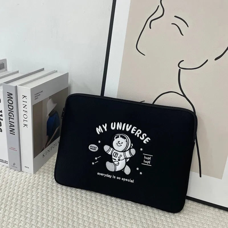 Embroidered laptop sleeve with animal design showing polyester construction and laptop size compatibility