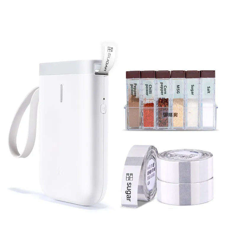D11 compact white Bluetooth thermal label printer with USB cable and roll of label paper on a desk.