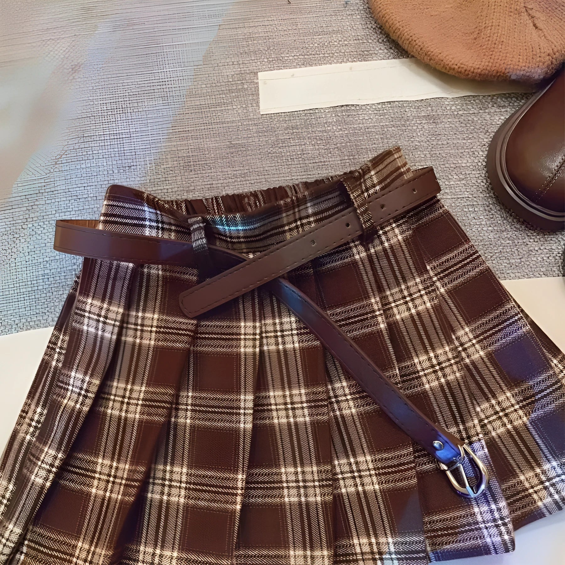 Girls plaid pleated A-line skirt in cotton-blend fabric on a hanger.