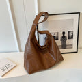 Soft leather shoulder bag in street style with sandwich pockets and sewing thread detailing