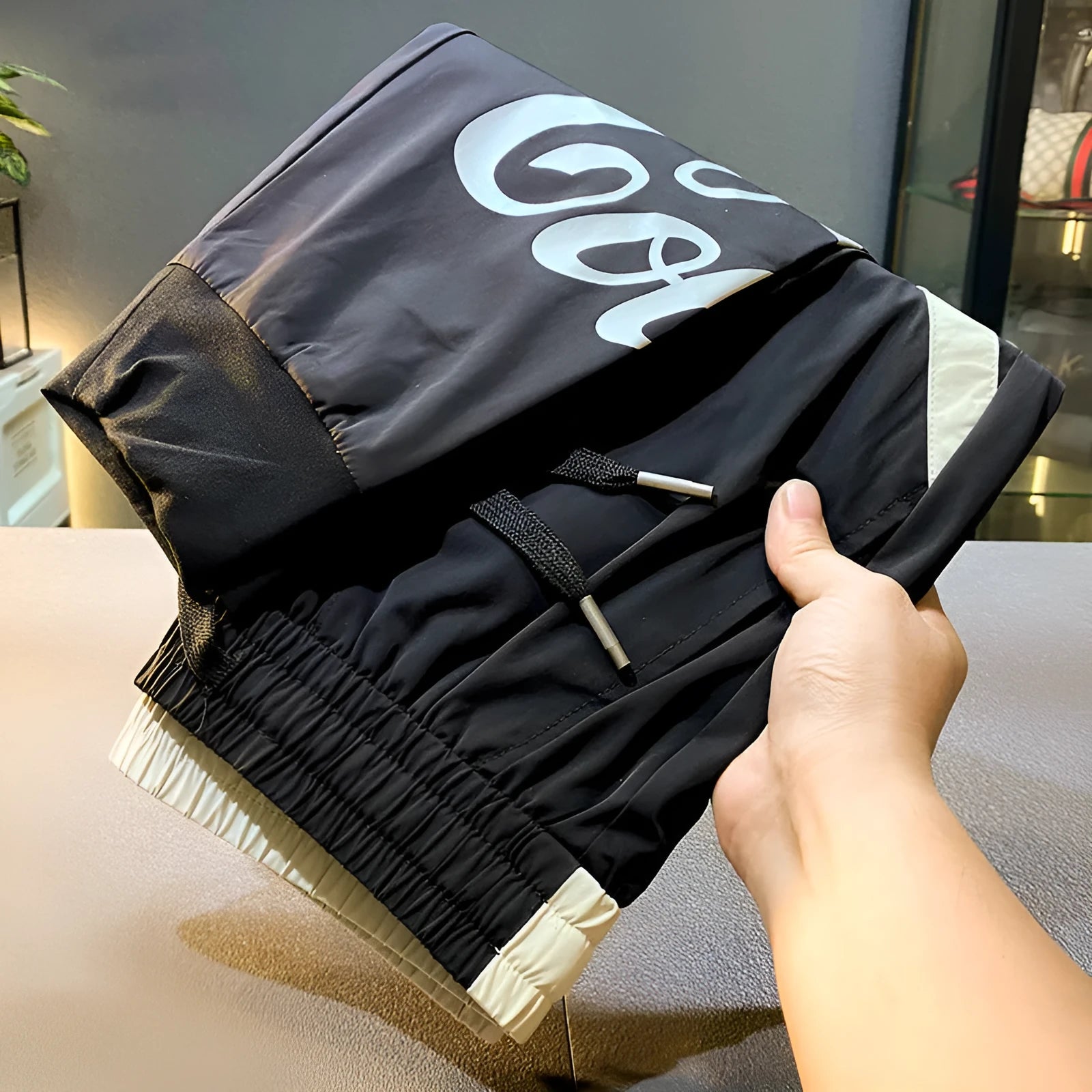Black men's cropped casual trousers with an ankle band, made from thin Ice Silk cotton fabric.