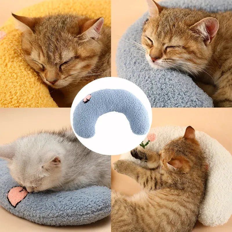 Small U-shaped plush pillow for cats and small dogs in blue colour, showing quilted faux fur texture.