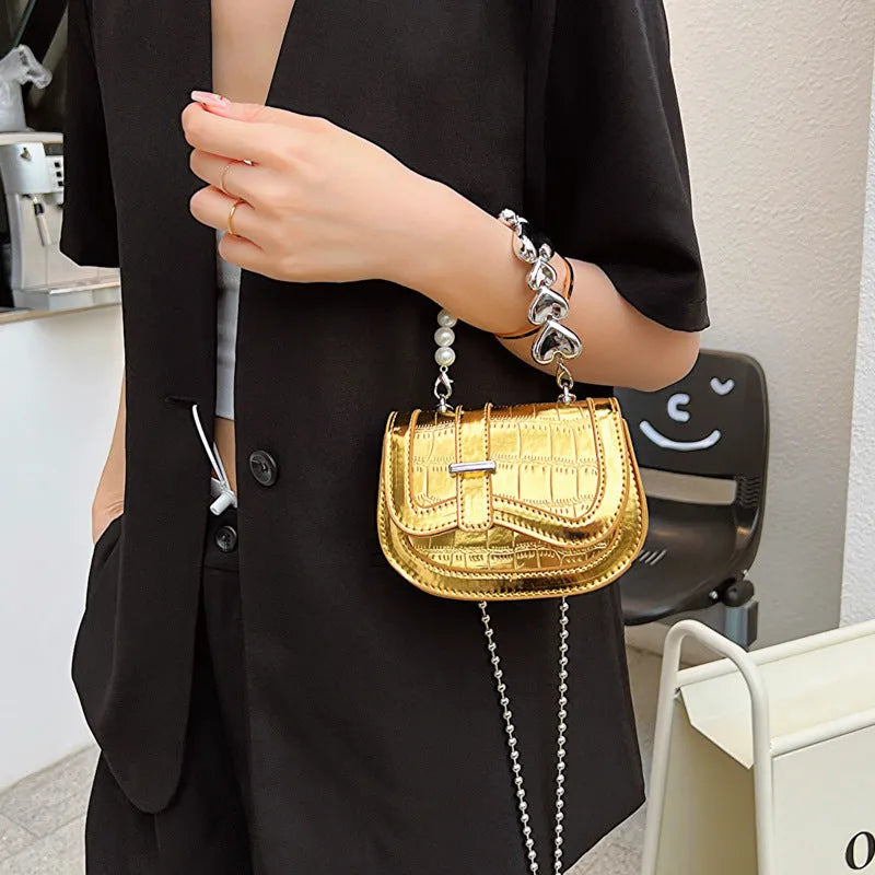 Women's silver PU crossbody bag showing horizontal square tote saddle shape and single shoulder strap