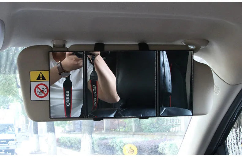 Silver car folding makeup mirror shown both closed at 15.5cm and open at 30.5cm wide.