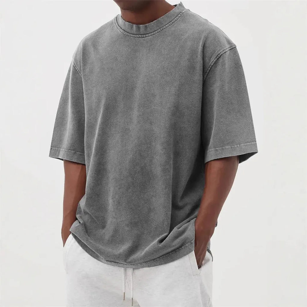 Men's stone-washed distressed loose fit t-shirt in army green colour on a hanger.