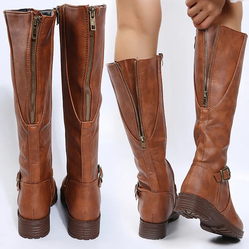 Women's black knight-style ankle boots with a buckle strap and square heel on a white background.