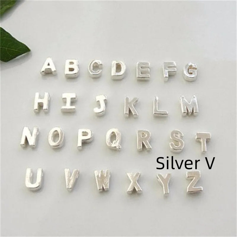 Gold and silver alloy peach heart shaped letter pendant necklace charm on a chain.