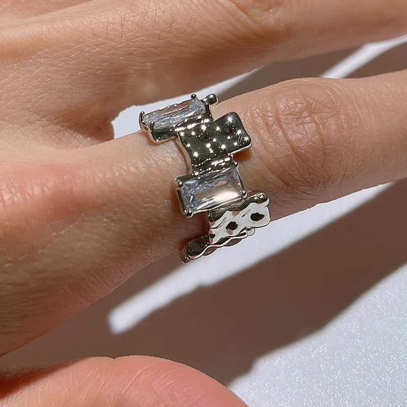Geometric open silver ring with cross zircon gemstones and three-dimensional decoration