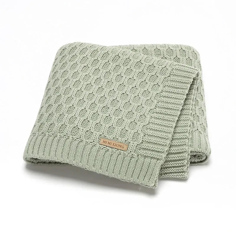 Infant hug blanket with three-dimensional lines in solid colours including pink and beige khaki