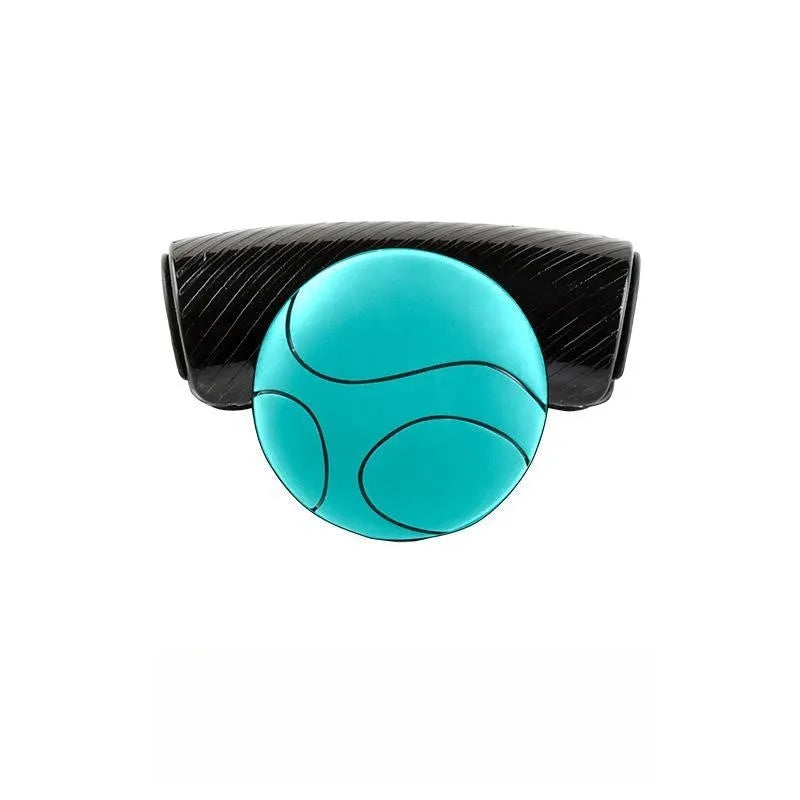 Black and blue silicone steering wheel assist balls showing size against a car steering wheel.
