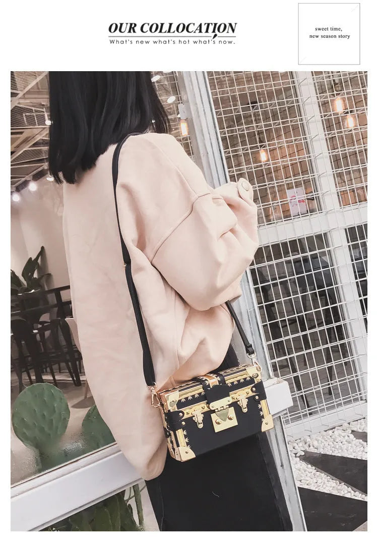 Women's hard-sided black PU shoulder bag with single strap and flap closure