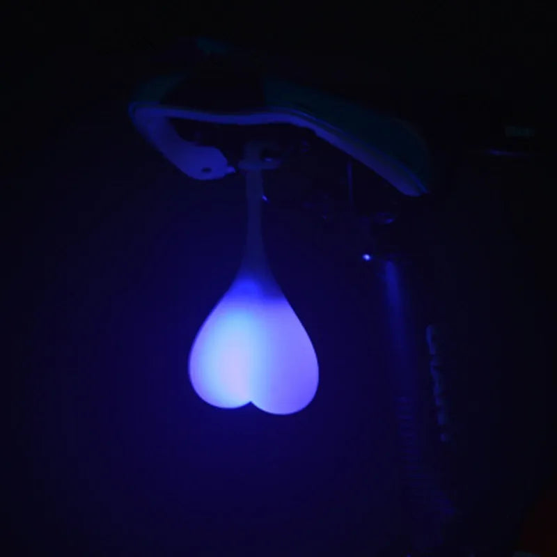 Heart-shaped silicone bike rear light, 15 cm long, touch activated, waterproof, in red blue green.
